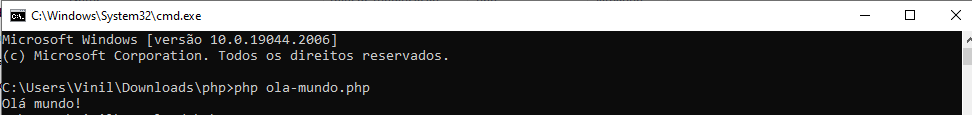 Imagem do CMD do Windows, digitando o comando: php ola-mundo.php, e obtendo o seguinte resultado: 'Olá mundo' "