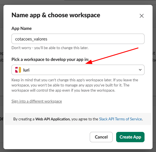 Janela pop-up do Slack com o título "Name app & choose workspace". No campo App Name, está escrito cotaçoes_valores. Abaixo, há a seção "Pick a workspace to develop your app in:", com um menu suspenso selecionado para o workspace chamado luri (indicado por uma seta vermelha). No rodapé, há dois botões: Cancel (à esquerda) e Create App em verde (à direita)