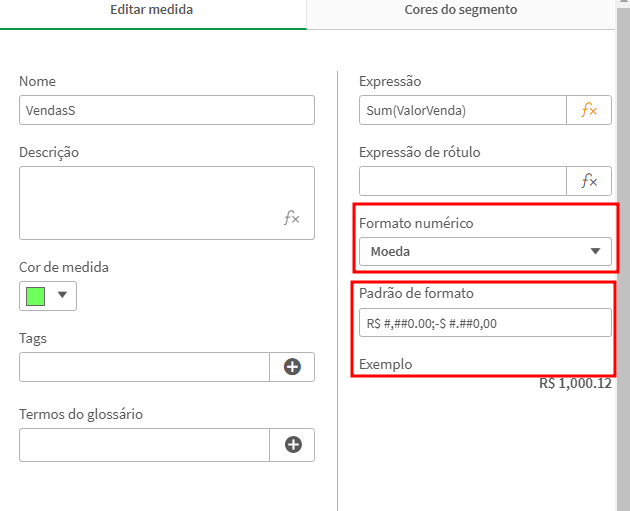 A imagem exibe a interface de edição de uma medida no Qlik Sense. O nome da medida é "VendasS", com campos adicionais para descrição, cor de medida (selecionada como verde), tags e termos do glossário. À direita, a expressão configurada é `Sum(ValorVenda)`. O formato numérico está definido como "Moeda", e o padrão de formato está configurado como `R$ #,##0.00;-R$ #,##0.00`, com um exemplo exibido como "R$ 1.000,12". Acima, há uma aba chamada "Cores do segmento", indicando a existência de outras configurações disponíveis. 