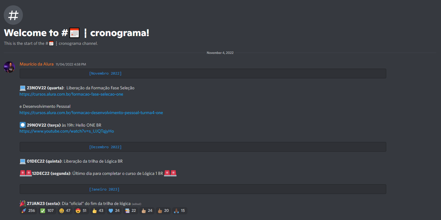 Imagem de *screenshot* feita do canal #cronograma do servidor "ONE - Fase seleção" pelo Discord. Nessa imagem, vemos títulos relacionados ao assunto e posts do Maurício da Alura referentes ao calendário de eventos e tarefas a serem realizadas nesta fase. O fundo é azul escuro, cada texto contém um emoticon referência e as letras e palavras são na cor branca. Além disso, há a reação de muitos usuários da comunidade, visíveis por emoticons alegres.