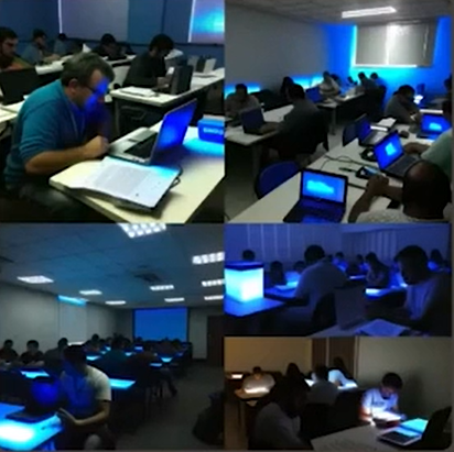 Quatro ilustrações digitais coloridas fotorrealistas de salas de aula ocupadas por pessoas usando computadores.